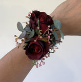 Artificial burgundy roses with berries and greenery corsage for school ball