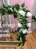 Welcome sign with white roses